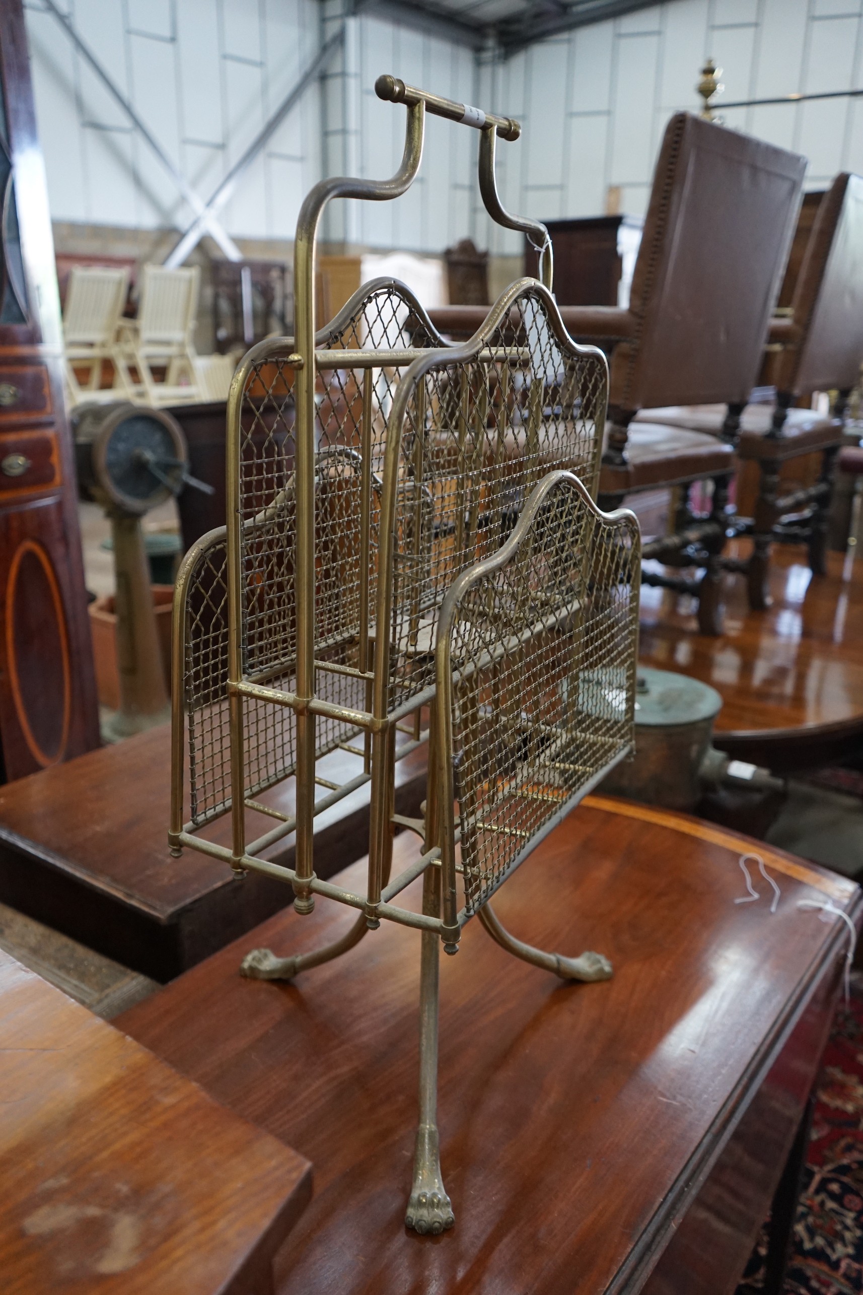 An Edwardian gilt metal wirework four division magazine rack